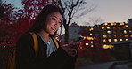 Happy asian woman, phone and night at city for social media, communication or outdoor networking. Female person smile on mobile smartphone in late evening for online chatting in urban town of Japan