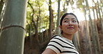 Japanese woman, bamboo trees and and walking in forest for hiking, travel adventure and freedom in nature from below. Happy lady, thinking and explore jungle, environment and peaceful garden in woods