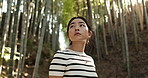 Woman, bamboo trees and thinking in forest for hiking, adventure or walking to travel in nature. Japanese tourist wonder for inspiration in environment, jungle and peaceful garden, woods or calm park