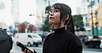 Japanese woman in city with phone, thinking and happy with internet connection on morning commute. Search, schedule or travel, Asian girl in street with smile checking location on smartphone in Tokyo