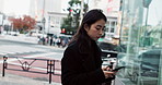 Japanese woman in city walking with phone, typing and reading online on morning commute. Search, schedule and travel, Asian girl on street checking email or post on smartphone app on journey in Tokyo