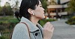 Japanese businesswoman, travel and walking to work, smartphone and wireless earphones on streaming playlist. Young person, entrepreneur and cellphone with digital podcast and connection in urban town