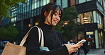 Japanese woman, phone and direction in city with smile, walking or thinking with map by buildings. Person, pedestrian and smartphone with location, schedule or information for address on metro street