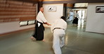 Motion, fight and dojo with sensei for aikido training, fitness and development with wooden sword exercise. Teaching, learning and student in traditional Japanese martial arts class with aikidoka.