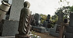 Stone statue in traditional Japanese cemetery with peace, calm and quiet landscape for memorial tombstone sculpture. Buddha monument in outdoor graveyard with zen, Asian culture and spiritual history