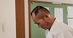 Aikido, master and man bow in respect for martial arts, class or walking in traditional gym. Japanese, sensei and mature fighter with humble greeting or welcome to competition with kindness and honor