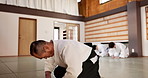 Martial arts students, sensei or bow in dojo for aikido practice, discipline or self defense in class. Respect, floor or Japanese master teaching combat or training workout for fighting or education