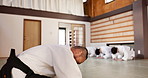 Martial arts students, master or bow in dojo for aikido practice, discipline or self defense in class. Respect, floor or Japanese master teaching combat or training workout for fighting or education