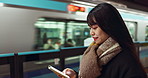 Japanese woman, phone and train station for transport with app, waiting and happy for travel in metro. Girl, smartphone and smile for commute with locomotive for journey, social media or web in Tokyo