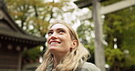 Woman, forest and torii gate in Kyoto with peace, mindfulness and travel with spiritual history. Architecture, japanese culture and shinto shrine in woods with sculpture, memorial and monument