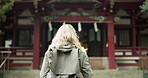 Torii gate, woman or back in japan for worship, holy or prayer location for peace in culture. Kyoto architecture, person and Fushimi Inari Taisha with religion and gateway of sacred to shinto shrine