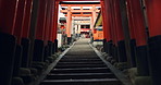 Stairs in Torii gate tunnel with temple, peace and mindfulness on travel with spiritual history. Architecture, Japanese culture and steps on orange path at Shinto shrine monument in forest in Kyoto