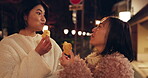 Woman, friends and street food or eating Japanese snack for travel experience, hungry or local trip. Female people, sidewalk and night walk on vacation for nutrition culture, adventure or traditional