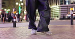 Closeup, feet and person dancing in city, moving body and freedom for street performance in night. Girl, dancer or sneakers for art, concert and steps with creativity, metro road and balance in Tokyo