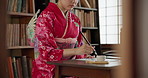 Woman, brush and ink for Asian writing or script with paper, document and creativity, calligraphy and traditional text. Japanese font, writer with black paint and person at desk with art and tools