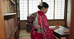 Japanese woman, ink and calligraphy for writing poetry, creativity or art with drawing in home. Girl, person or writer with pen, thinking and ideas with vision, paper and haiku for culture in Tokyo