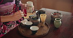 Herbs, teapot and Asian woman with tea for culture with traditional leaves and flavor in home. Wellness, ceremony and person with herbal beverage for relaxing, calm and detox for drinking ritual