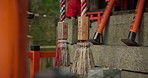 Japanese, rope and shrine with spiritual, religion and history of a rock structure with writing in Japan. Concrete, zen and Asian culture with red pillar and lantern outdoor with stone for memorial