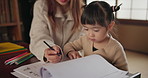 Japanese Mom, child and education with homework, writing and books for study, development and helping hand. Learning, mother and daughter with notes, pen and check progress in family house with study