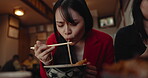 Woman, noodles and eating food in restaurant for nutrition, healthy meal and closeup with chopsticks. Person, Japanese cuisine and ramen for lunch or dinner in cafeteria with vegetable and hungry
