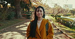 Outdoor, face and Japanese woman with sunshine, park and journey with vacation, daydreaming and wonder. View, outside and person with nature, summer or freedom with wellness, holiday and adventure