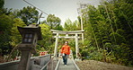 Japanese man, shinto torii gate and stairs on adventure, religion and faith by trees, thinking and ideas on journey. Person, religion or park for peace, mindfulness and steps in green forest in Kyoto