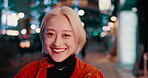 Woman, face and city or night light for explore urban Japan,  vacation adventure or evening celebration. Female person, smile and international travel in town or weekend for outdoor, relax or holiday