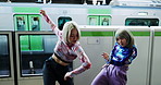 Women, dancer and station for train, travel and art with futuristic techno steps for street performance. Girl friends, Japanese dance team and rave in night, synergy and moving body together in Tokyo