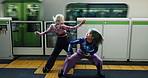 Women, dancing and station for train, travel and art with futuristic techno steps for street performance. Girl friends, Japanese dancer and rave in night, synergy and moving body together in Tokyo