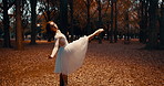Woman, dancer and ballet in trees, night and moving body for fantasy, nature and freedom in performance. Person, girl and ballerina with dancing, steps and outdoor in dark woods, autumn and forest