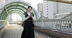 Japanese women, walking and smartphone on bridge for travel, texting and digital connection on weekend. Person, smile and typing on cellphone in tokyo town for holiday, social media and relax outdoor