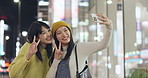 Smile, friends and selfie in city, hand gesture and photography for memory outdoor in Tokyo Japan at night. Happy women, girls and picture of people in urban town together, peace sign or finger heart