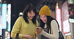 Friends, walking home and cellphone for social media, laughing and happy with comments. Japan, public transport and streaming online with technology, funny and meme humour with communication