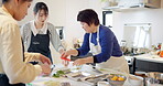 Women, chef and cooking traditional or Japanese meal for teaching, class or learning. Female person, students and kitchen instruction to prepare ramen bowl for nutrition, travel or local experience