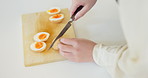 Boiled egg, food and hands of person in kitchen for eating, meal preparation and cuisine. Home, cooking and closeup of chef cutting for lunch, dinner and supper for wellness, diet and nutrition