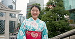 Face, traditional outfit and Japanese woman with a smile, city and peaceful with confidence, fashion and calm. Portrait, person and girl with stylish clothes, street and travel with beauty and happy