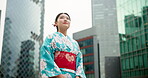Japanese woman, happy and travel in city with kimono, view and tour of cbd in positive attitude with wellness. Person, smile or traditional clothes by urban town buildings or journey in tokyo culture