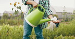 Farming, hands and farmer with watering can for vegetables growth, harvest and gardening on farm. Agriculture, sustainability and person with water for crops, plants and nature for agro business