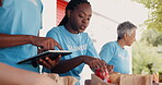 Volunteering, group of people and tablet for food donation, community service and poverty support with NGO checklist. Nonprofit manager, teamwork and groceries bag for distribution or charity project