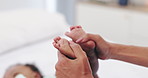 Hands, feet and mother with baby on a bed with bonding, support and security in their home together. Toes, love and mom with kid in a bedroom for comfort, reflexology massage and safety with care