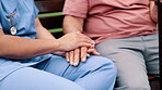 Bench, support or closeup of nurse holding hands with patient for healthcare, wellness and service. Outdoor, love and caregiver in a park with a helping a senior person for medical advice or nursing