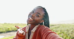 Woman, face and selfie as influencer outdoor for online content creator for connection, adventure or holiday. Black person, smile and blow kiss on grass field for summer travel memory, blog or vlog