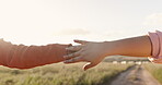 People, hands and connection in sunset love for holiday bonding, romance or affection. Couple, fingers and touching on vacation for honeymoon together or outdoor sunshine, partnership or marriage