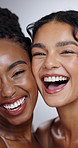 Women, face and beauty with laughing in studio with facial treatment, diversity or glowing skin. Friends, model and portrait with mock up for cosmetics, dermatology and support on white background