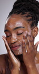Hands, face and soap for skincare with black woman in studio on gray background for wellness cleanse. Beauty, cleaning and facial with young person in bathroom for dermatology, hygiene or hydration