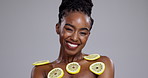 Happy black woman, lemon and skincare for vitamin C, beauty or detox on a gray studio background. Portrait of African female person or face of model smile with natural organic citrus fruit on mockup