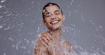 Water splash, skincare and woman on gray background for cleaning, wellness and cosmetics to shower. Dermatology, beauty and person with drops for washing, facial treatment and healthy skin in studio