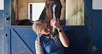 Woman, kiss horse and stable in farmhouse, countryside and ready in ranch for sustainable farming. Farm, nature and outdoor, adventure and animal livestock with cowgirl, pet care and female jockey
