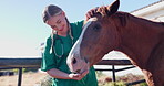 Vet, woman and horse with health at farm for carrot, feeding or helping for nutrition with vegetable. Doctor, veterinary person and animal for eating, diet or wellness at countryside ranch in Texas