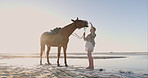 Beach, woman and horse in nature for training, bonding or fun adventure on summer, holiday or trip. Ocean, freedom and female person with stallion at the sea for fresh air, travel or outdoor break